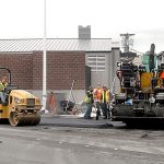 A paving crew from Lakeside Industries installs asphalt Wednesday at the alley access to a new wastewater pump station along Marine Drive in Port Angeles. (Keith Thorpe/Peninsula Daily News)