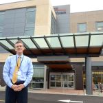 Jefferson Healthcare CEO Mike Glenn stands in front of the hospital&rsquo;s new building, which will open officially Monday after a ribbon-cutting Sunday. (Cydney McFarland/Peninsula Daily News)