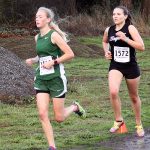 Dave Logan/For Peninsula Daily News                                Port Angeles&rsquo; Gracie Long, left, won the Olympic League girls cross country title while Sequim&rsquo;s Morgan Bingham finished second. The Roughriders claimed the team title as well.