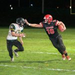 Steve Mullensky/for Peninsula Daily News                                Port Townsend&rsquo;s Detrius Kelsall, 10, stiff-arms Vashon&rsquo;s Connor Hoisington, during a Friday game played in Memorial Field in Port Townsend.