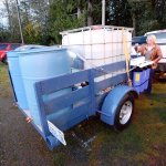 Connie Beauvais, Crescent Water Association manager, pulls a lever on the Joyce Emergency Planning and Preparation group&rsquo;s portable hand-powered water purification system Monday. (Jesse Major/Peninsula Daily News)