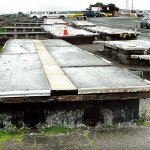 Sections of floating dock that had provided temporary seasonal moorage at Port Angeles City Pier sit in storage at Ediz Hook in this March 2013 photo. (Keith Thorpe/Peninsula Daily News)