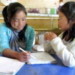Mujeres de Maiz Opportunity Foundation of Clallam County scholarship recipient, Erika, in February helps a young student attending the Crucero Saturday Children&rsquo;s Program. (Judith Pasco)                                Mujeres de Maiz Opportunity Foundation of Clallam County scholarship recipient Erika, left, in February helps a young student attending the Crucero Saturday Children&rsquo;s Program. (Judith Pasco)