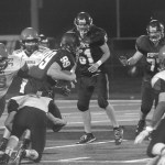 Lonnie Archibald/for Peninsula Daily News                                Forks&rsquo; Jack Dahlgren (99) runs through Neah Bay defenders Curtis LaChester (39) Cole Svec (16) and Logan Halttunen (8) and Josey Tyree (18) on his way to a big gain earlier this season. The Spartans host Hoquiam tonight with a shot at the Evergreen League&rsquo;s second seed to the district playoffs.