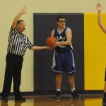 Lonnie Archibald/for Peninsula Daily News North Olympic Basketball Officials Association member Brad Archibald hands the ball over for an inbounds pass during an Elma-Forks basketball game. The association is looking for more officials to join its ranks.