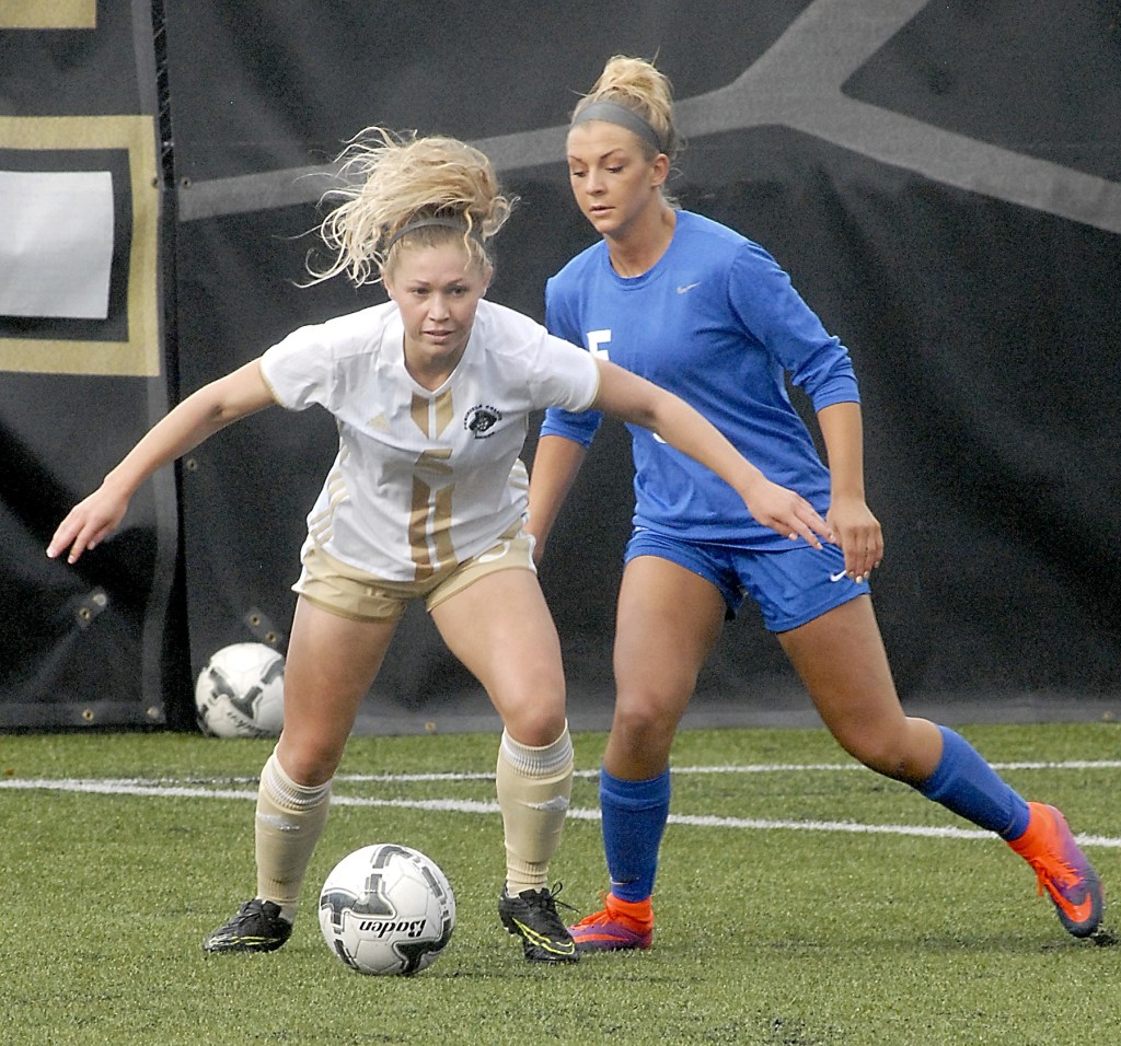 Keith Thorpe/Peninsula Daily News                                Peninsula&rsquo;s Ellie Small, front, fends off the defense of Edmonds&rsquo; Kylie Morse in the first half Saturday in Port Angeles.