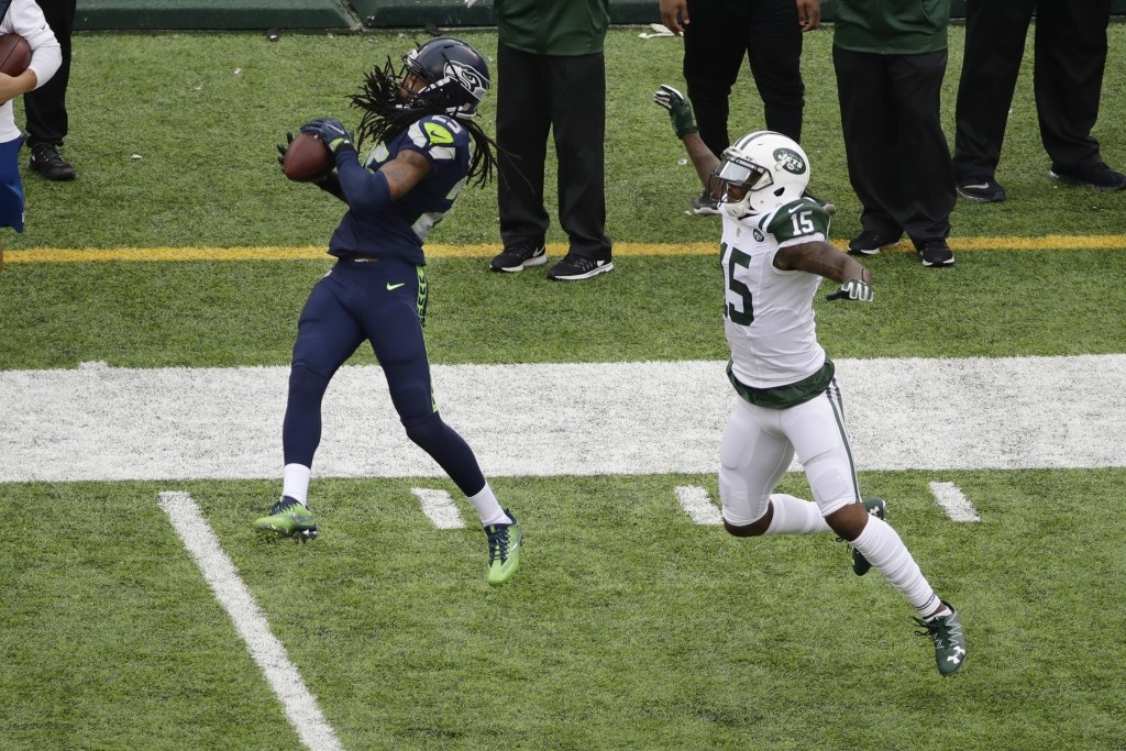 Seattle Seahawks cornerback Richard Sherman (25) intercepts a pass to New York Jets&rsquo; Brandon Marshall (15) during the second half of an NFL football game Sunday, Oct. 2, 2016, in East Rutherford, N.J. (AP Photo/Peter Morgan)