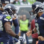 Seattle Seahawks quarterback Russell Wilson, right, celebrates with teammate C.J. Spiller, left, after they connected for a touchdown during the first half of an NFL football game against the New York Jets, Sunday, Oct. 2, 2016, in East Rutherford, N.J. (AP Photo/Bill Kostroun)
