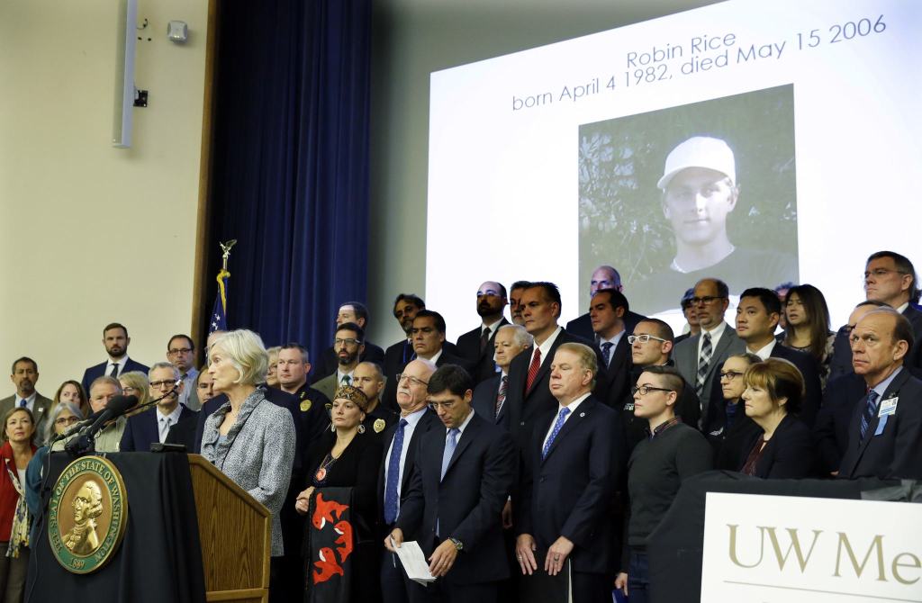 Dr. Rosemary Orr, lower left, speaks at the University of Washington Medical Center in Seattle on Friday about the 2006 opioid overdose death of her son, Robin Rice. Orr spoke with Washington Gov. Jay Inslee, who announced an executive order to fight the rising abuse of opioids in Washington state. (Ted S. Warren/The Associated Press)
