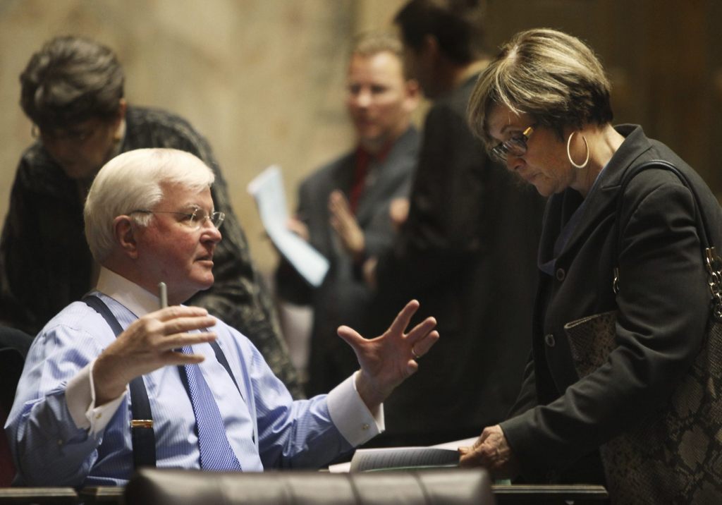Sam Hunt, D-Olympia, left, talks with with Rep. Sharon Wylie D-Vancouver in Olympia in January 2012. Hunt is a supporter of a measure on the ballot in November that would place an income tax on the highest earners who reside in Olympia to pay for a portion of first-year college or technical school expenses for all Olympia public high school graduates and GED recipients. (Steve Bloom/The Olympian via AP)