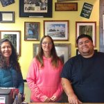 From left, Sandy Taylor, a visitor from Sequim, stands with Lee Hunter and Phil Sifuentes of the Forks Visitors Center. (Zorina Barker/for Peninsula Daily News)