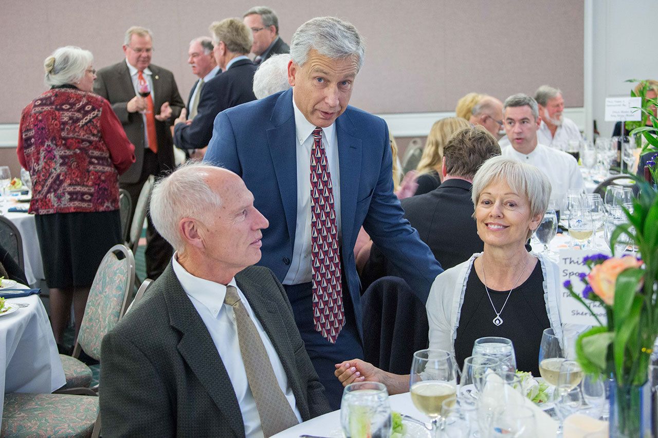 Bill and Esther Littlejohn, seated, talk with Olympic Medical Center CEO Eric Lewis at the Harvest of Hope event last Saturday. The Littlejohns donated $100,000 toward OMC&rsquo;s capital campaign, which includes expansion of the Olympic Medical Center Cancer Center. (Justin Charon)