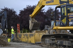 Crewmen with Pacific Civil and Infrastructure, the contractor for the Carlsborg sewer project, dig out an 8-inch sub-main line along Carlsborg Road and Business Park Loop for the gravity-fed sewage collection system Tuesday. (Matthew Nash/Olympic Peninsula News Group)
