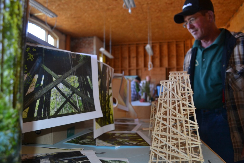 John Kumparak, vice president of the North Olympic Peninsula Railroaders, stands by the club&rsquo;s replica of the Johnson Creek Trestle. As they work on it, club members say they are using individual photographs to ensure authenticity. (Matthew Nash/Olympic Peninsula News Group)