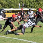 Lonnie Archibald/for Peninsula Daily News Neah Bay&rsquo;s Rwehabura Munyagi (10) avoids Lummi&rsquo;s Raven Borsey (13) in Neah Bay&rsquo;s game against Lummi in September. Also in on the play from Neah Bay are from left, Caleb Revey (21) Phillip Greene (12).