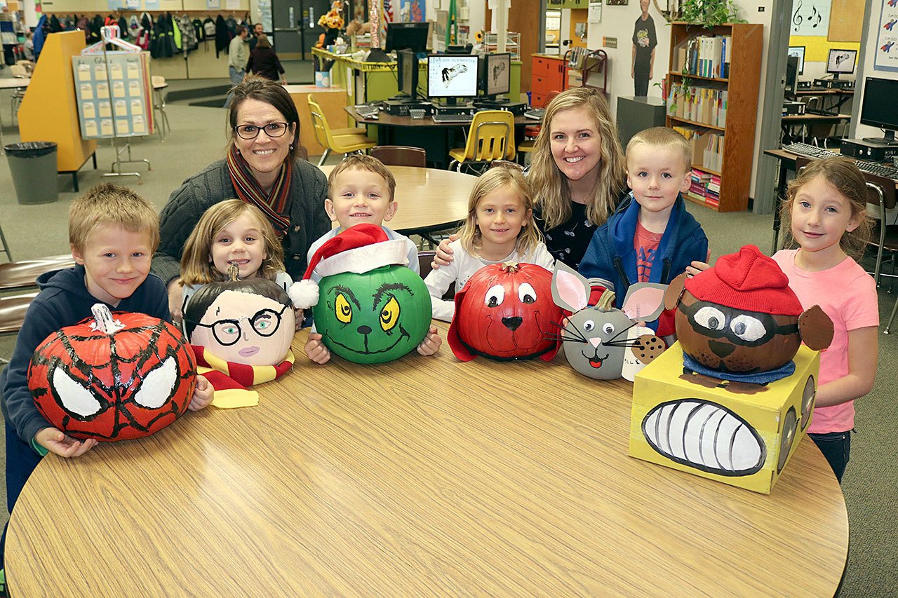 From left, Brenden McMahan, Lucy Townsend, teach Michelle Weber, Warren Reynolds, Storey Schmidt, teacher Sara Hochberger, Christopher Swegle and Kamryn Warsky show off decorated pumpkins. Not pictured are teacher Lisa McCoy. (Port Angeles School District)