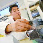 Juan Juan, a second-year Peninsula College student in the advanced manufacturing program, shows some recycled carbon fiber during an open house at the Composite Recycling Technology Center in Port Angeles on Tuesday evening. (Jesse Major/Peninsula Daily News)