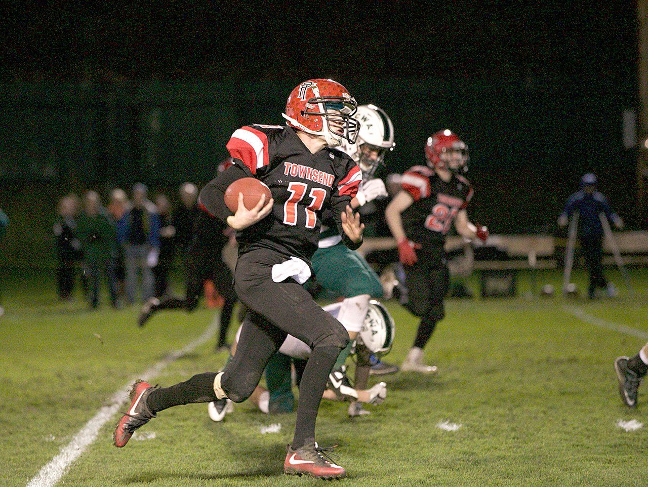 Steve Mullensky/for Peninsula Daily News                                Port Townsend&rsquo;s Berkley Hill races upfield for a big gain in the first quarter of the Redhawks&rsquo; 49-7 victory over Charles Wright at Memorial Field. Port Townsend clinched its second straight state berth with the win.