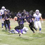 Michael Dashiell/Olympic Peninsula News Group Sequim&rsquo;s Tyler Conn (34) runs against Eatonville with teammates Brenden Lauritzen (75) and Rudy Whitehad (33) blocking. Eatonville won the 2A District playoff shootout by a score of 59-42.