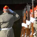 Mark Schildknecht, left, salutes into the aviation hangar after leading a three-volley rifle salute conducted by Mount Olympus Detachment 897 of the Marine Corps League on Veterans Day last year. (Keith Thorpe/Peninsula Daily News)