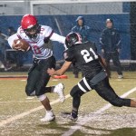 The Daily World Neah Bay&rsquo;s Rwehabura Munyagi Jr. fends off the defense of Taholah&rsquo;s Brett Orozco during the Red Devils&rsquo; 58-22 win over the Chitwins at Stewart Field in Aberdeen.