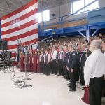 A combined chorus consisting of members of the Olympic Peninsula Men&rsquo;s Chorus, the Grand Olympics Chorus of Sweet Adeline&rsquo;s International, Mix Up A Capella and the Sequim High School Select Choir perform under the direction of Jim Davis during Friday&rsquo;s Veterans Day ceremony in the hangar of U.S. Coast Guard Air Station/Sector Field Office Port Angeles. (Keith Thorpe/Peninsula Daily News)