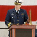 A family heirloom bugle graces the dais as U.S. Coast Guard Cmdr. Mark Hiigel, commanding officer of Air Station/Sector Field Office Port Angeles, speaks during Friday&rsquo;s Veterans Day ceremony. (Keith Thorpe/Peninsula Daily News)