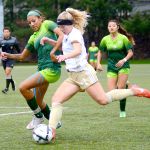 Jay Cline/For the Peninsula Daily News Peninsula&rsquo; Maddy Parton (11) dribbles against Highline during the women&rsquo;s championship match Sunday. The women won in the second overtime 1-0.