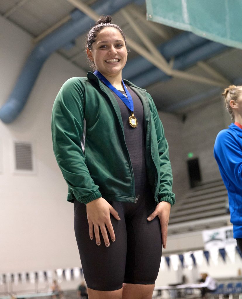 Port Angeles High School photo                                Port Angeles&rsquo; Jaine Macias receives her medal for winning the 100-yard breaststroke at the State 2A Swim and Dive Championships Saturday at the King County Aquatic Center.