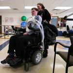 Heather Werdal helps her son Hayden after another session in the rehabilitation gym at Harrison Medical Center in Silverdale. As medical experts puzzle over the mysterious, polio-like illness that has afflicted eight Washington children this fall, Hayden, paralyzed by the same syndrome two years ago, struggles to recover. (Alan Berner/The Seattle Times via AP)