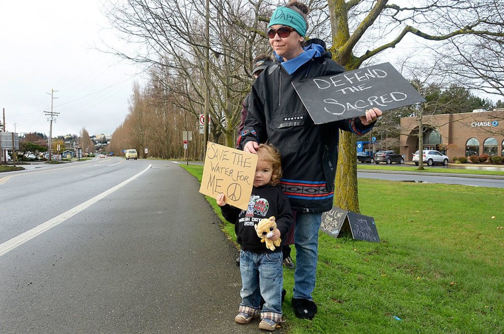 Sabrina Hill and 3-year-old Mary Hill participated in a protest against the Dakota Access Pipeline on Tuesday in Port Townsend. The protest was one of many happening across the United States for the National Day of Action in Support of Standing Rock. (Cydney McFarland/Peninsula Daily News)