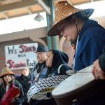 Jonathan Arakawa, a Lower Elwha Klallam Tribe member, drums alongside other tribal members during a protest of the Dakota Access Pipeline in downtown Port Angeles on Tuesday afternoon. (Jesse Major/Peninsula Daily News)