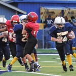 Lonnie Archibald/for Peninsula Daily News Forks A squad running back Nate Dahlgren (24) finds running room against Neah Bay during the West End Youth League Football Championships last Saturday. Forks defeated the Warriors 18-12 in triple overtime. Chimacum topped Neah Bay 33-20 in the B squad title game, while Forks knocked off Sequim 30-20 in the C squad championship.