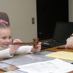 Four-year-old Berit Anala Knight-Porter-Walter plays with a gavel belonging to Clallam County Superior Court Commissioner Brent Basden prior to a court proceeding to officially award her to adoptive mother Debby Walter of Port Angeles on Thursday in Port Angeles. (Keith Thorpe/Peninsula Daily News)