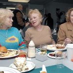 Diners, from left, Tina Harris of Port Angeles and Sande Fast and Beth Frazee, both of Sequim, share a moment of levity during the annual free community Thanksgiving dinner at Queen of Angels Catholic Church in Port Angeles last year. (Keith Thorpe/Peninsula Daily News)