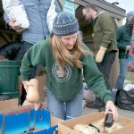 Candice Cofler, from Port Townsend and a volunteer with Standing Rock Thanksgiving Caravan, sorts groceries Sunday destined for the pipeline protesters in Standing Rock. (Steve Mullensky/for Peninsula Daily News)
