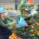 Sue Fink of Silverdale decorates a marine life-themed tree titled &ldquo;Swimming Free&rdquo; on Tuesday in preparation for this weekend&rsquo;s Festival of Trees at the Vern Burton Community Center in Port Angeles. The festival, which begins today with the annual Teddy Bear Tea and Festival of Trees gala and auction, is a benefit for the Olympic Medical Center Foundation. (Keith Thorpe/Peninsula Daily News)