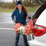Shirley Moss, manager of the Jefferson County Food Bank, unloads a donation of onions Tuesday in preparation for the busy Thanksgiving holiday. (Cydney McFarland/Peninsula Daily News)