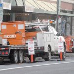 Temporary no-parking signs mark an area along West First Street in downtown Port Angeles on Wednesday where crews have removed trees to repair buckled sidewalks. (Keith Thorpe/Peninsula Daily News)