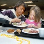 Tyrah Galbraith of Port Angeles, left, shares food with her daughter, Makailia Galbraith, 4, during Wednesday&rsquo;s pre-Thanksgiving lunch at the Salvation Army kitchen in Port Angeles. (Keith Thorpe/Peninsula Daily News)