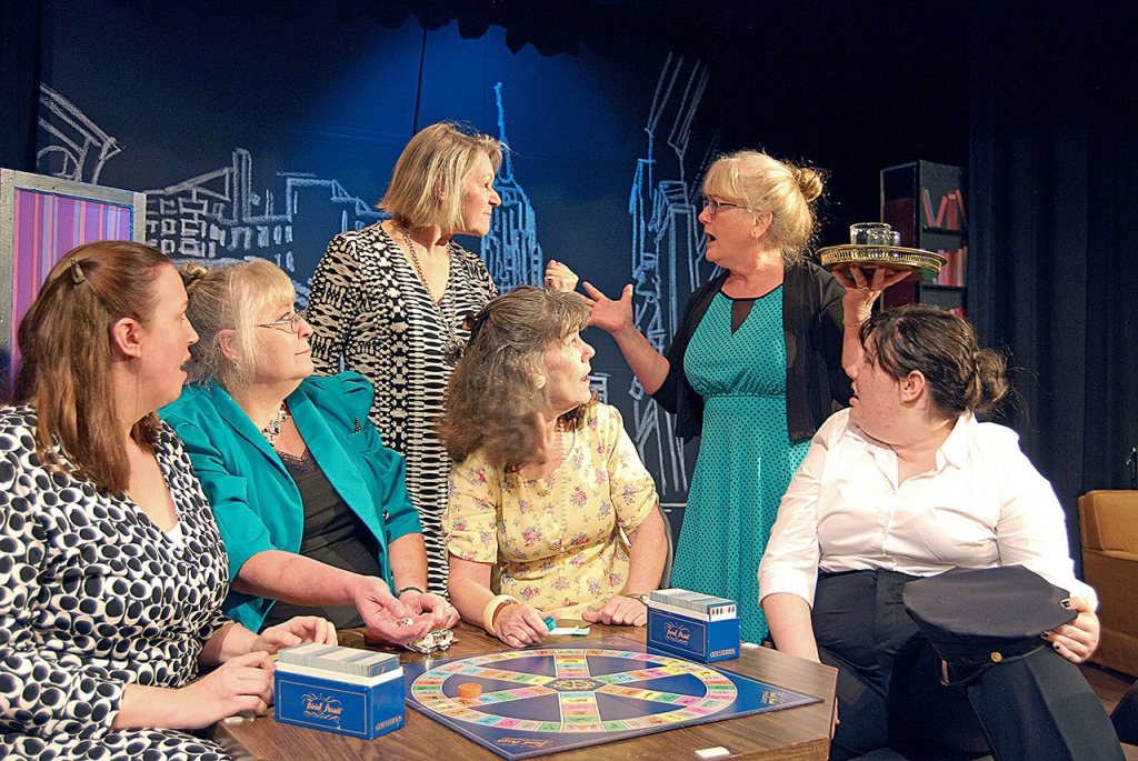Florence Ungar, portrayed by Janet Lucas, standing at right, and Olive Madison, portrayed by Lynne Murphy, standing at left, squabble during a rehearsal of &ldquo;The Odd Couple.&rdquo; (Robert Bronsink)