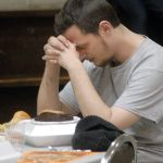 Nathan Winters of Port Angeles says a prayer of thanks before his meal at Thursday&rsquo;s community Thanksgiving dinner at Queen of Angels Catholic Church in Port Angeles. (Keith Thorpe/Peninsula Daily News)