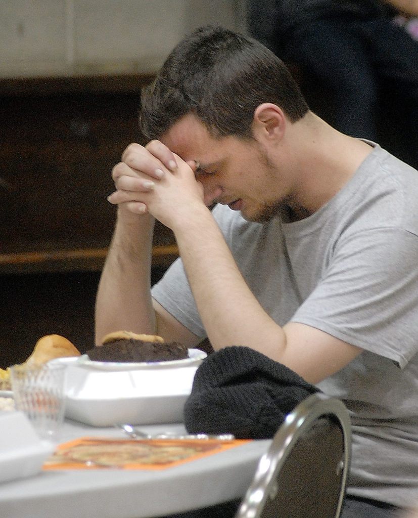 Nathan Winters of Port Angeles says a prayer of thanks before his meal at Thursday&rsquo;s community Thanksgiving dinner at Queen of Angels Catholic Church in Port Angeles. (Keith Thorpe/Peninsula Daily News)