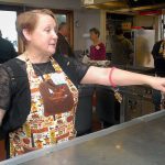 Dinner organizer Reath Ellefson directs traffic with cooks and helpers in the kitchen of the Queen of Angels gym for Thursday&rsquo;s Thanksgiving meal. (Keith Thorpe/Peninsula Daily News)