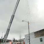 More than 1,300 pingpong balls redeemable for prizes pour from a Port Angeles Fire Department aerial ladder on Saturday in downtown Port Angeles. The &ldquo;Snowball Drop&rdquo; was hosted by the Port Angeles Downtown Association and took place under rainy conditions in a parking lot in the 100 block of West Front Street. (Keith Thorpe/Peninsula Daily News)