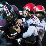 Photo by Evan Abell/Bellingham Herald                                Neah Bay&rsquo;s Rwehabura Munyagi, right, tackles Lummi&rsquo;s Raven Borsey Saturday at Everett Memorial Stadium in Everett.