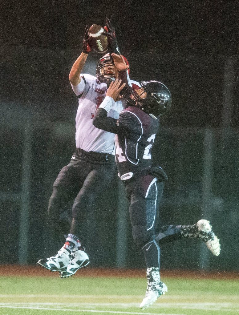 Photo by Evan Abell/Bellingham Herald                                Neah Bay&rsquo;s Kenrick Doherty Jr., left, catches a pass over Lummi&rsquo;s Noah Toby at Everett Memorial Stadium in Everett.