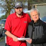 The Rev. Omer Vigoren of Bethany Pentecostal Church in Port Angeles, right, hands a $500 check to Jeff Bele, commander of Chapter 9 of the Disabled American Veterans in Port Angeles. The church is donating to a fund where 100 percent of the funds go toward helping disabled veterans financially. (Jesse Major/Peninsula Daily News)