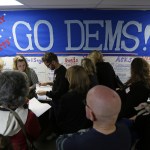 Volunteers get instructions for canvassing neighborhoods Friday following a get-out-the-vote rally at a campaign office in Seattle. (Ted S. Warren/The Associated Press)