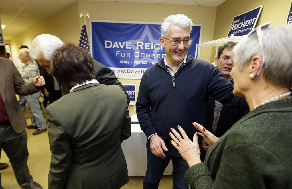 Bill Bryant, second from right, the Republican candidate for Washington state governor, talks to guests Friday during a get-out-the-vote rally at a campaign office in Issaquah. (Ted S. Warren/The Associated Press)